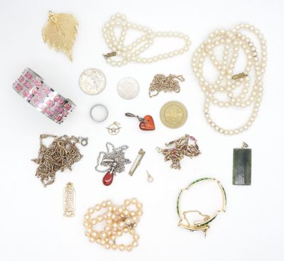 many different types of necklaces and bracelets laid out on a white surface