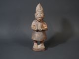 an old wooden statue of a woman holding a flower in her hands