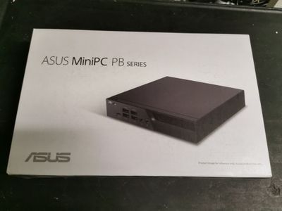 an asus mini pc pb series box sitting on top of a table