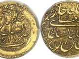 two gold coins with arabic writing on them