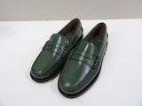 a pair of green shoes sitting on top of a white table