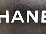 the word chanel is written in white on a black background