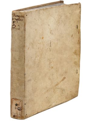 an old book sitting on top of a white surface