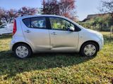 a small silver car that is parked in the grass