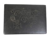 a close up of a black leather book with a design on it