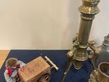 a table with a lamp, a box, and other items on it