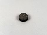 a small black piece of metal sitting on top of a white surface