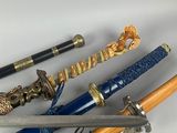 several different types of swords are lined up on a white surface