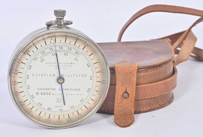 a pocket watch with a strap around it on a white surface