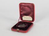 a small red case with a coin inside of it