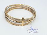 three gold and silver bang bracelets with a cross on each side