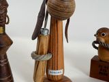 three wooden figurines of different shapes and sizes on a table