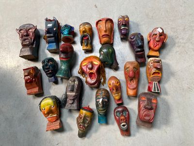 a lot of wooden masks on the floor