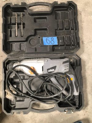 a tool in the case that is sitting on the floor next to a pair of shoes