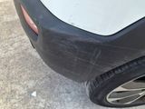 a close up of a car ' s rear bumper with scratches on it