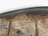 a close up of a silver vase with spoons in it