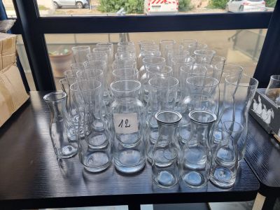 a lot of empty glasses on a table in front of a window