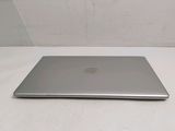 an open laptop computer sitting on top of a white table