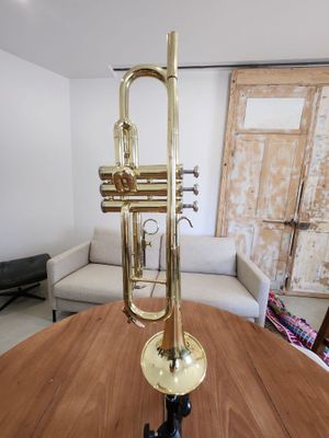 a brass trumpet sitting on a wooden table in a living room