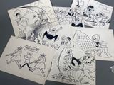 several drawings of cartoon characters are shown on a table
