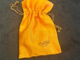 an orange bag with a logo on it sitting on a table