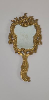 mirror with a gold frame on a white surface