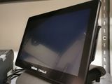 a small monitor sitting on top of a desk next to a printer