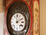 a grandfather clock hanging on the wall in the room