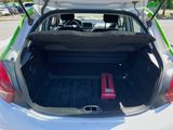 the back of a car with its trunk open and a red object in the trunk