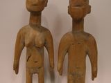 pair of wooden figurines of a man and a woman
