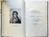 an open book with a picture of a man in a coat on top of a table