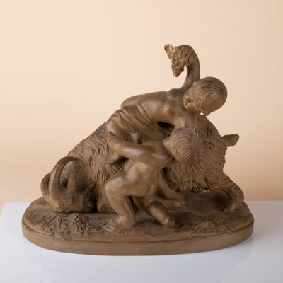 statue of a woman on a buffalo on a white surface