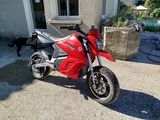 a red motorcycle parked in front of a house