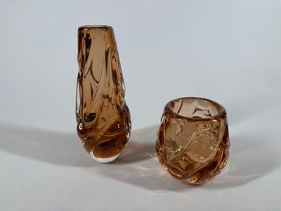 pair of brown glass vases sitting on top of a white surface