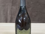 une vieille bouteille de vin posée sur une table en bois