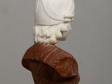a white statue of a man with a helmet on top of it