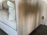 a white couch with pillows on it in a living room