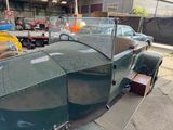 a green car that is parked in a garage