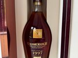 a bottle of whisky sitting in a box on a shelf