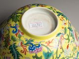 a yellow vase with a floral design on it