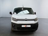 the white van is parked in a white room with a black floor