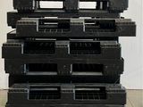 a stack of black plastic pallets stacked on top of each other