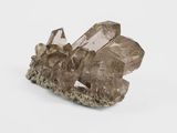 a close up of a cluster of crystals on a white surface