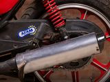 a close up of a red motorcycle with a blue logo on it