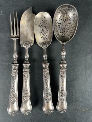 three spoons, a fork, and a knife on a table