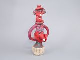 figurine of a man with a hat and scarf on his head