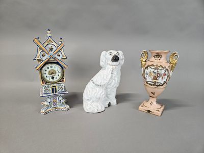 three figurines of dogs and a clock on a table