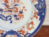 a blue and white plate with orange flowers on it