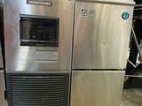 an image of a stainless steel refrigerator in a warehouse