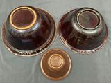 two brown vases sitting on a table next to each other